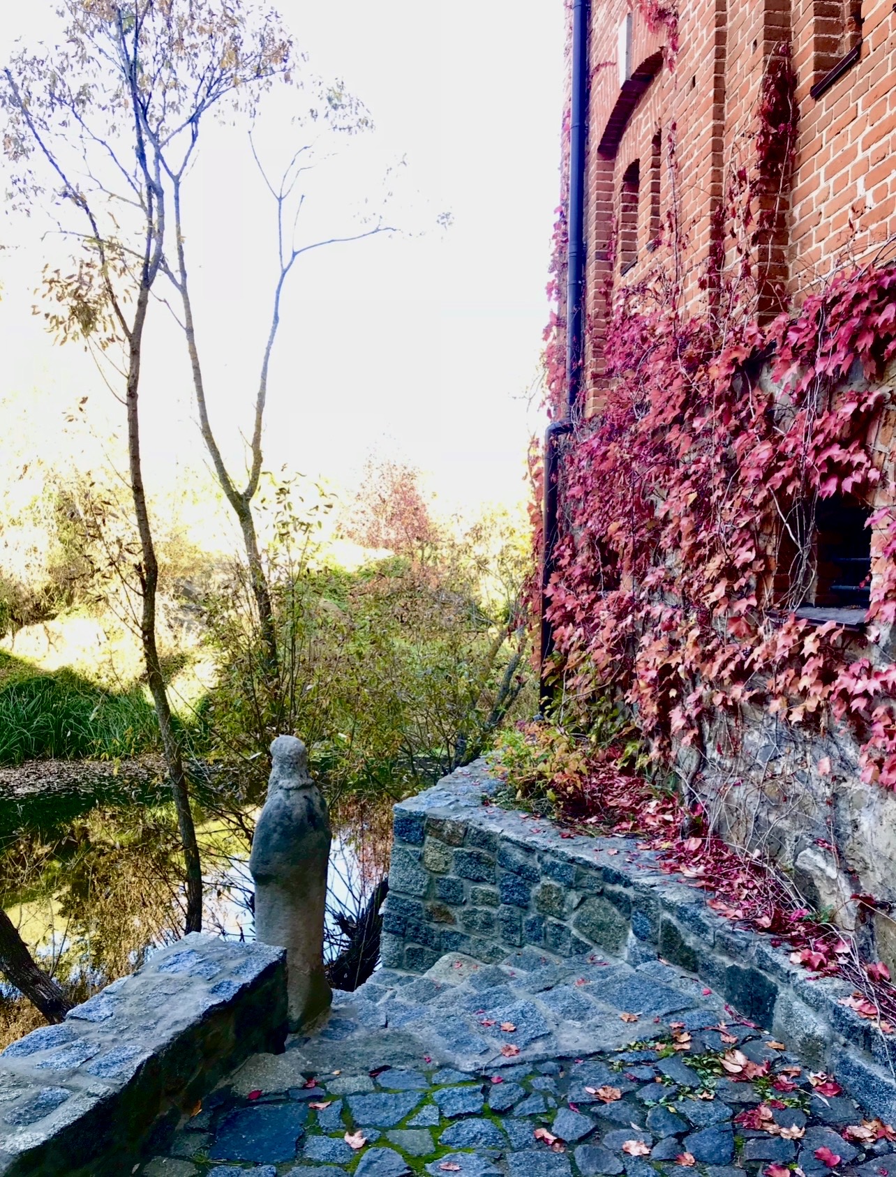 Stone steps leading from the castle towards the water and another silent guardian